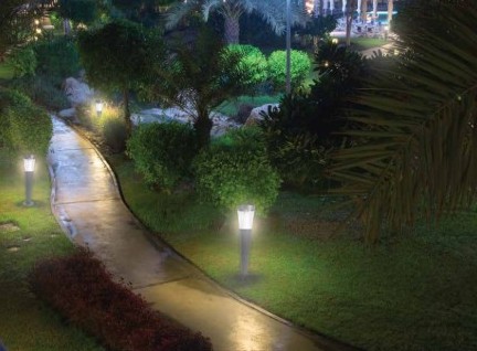 Solar garden and pathway lights along a landscaped walkway